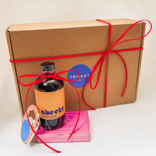 Load image into Gallery viewer, Gift box with a bottle of cocktail syrup, a card game, and a bottle opener on a light background